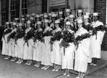 Photo of young ladies in graduation cap and gowns holding flowers;  Cumberland's Ursuline Academy Class of 1963