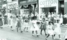 Circa 1957 of Young girls in dresses from Pine Ave marching in Cumberland Intra-City Playground Parade