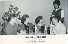 4 people at table with cokes order food from waitress at Harper's Parklane circa 1960s