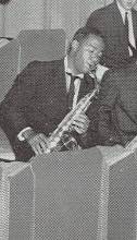 Clipped photo of young man playing a saxaphone