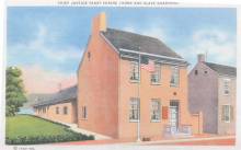 Postcard from 1930s; Red brick home with text above "Chief Justice Taney Shrine (Home and slave quarters)