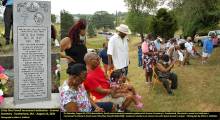 Critty Dias Powell Monument with family and friends in chairs and standing gathered to unveil monument