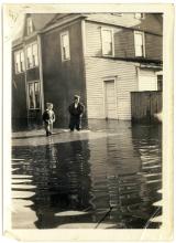 Photo of flooded Main Street in Hancock, 1936 Flood - 2 young boys walking through water at their knees