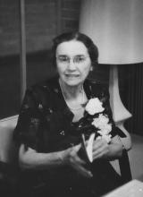 Photo of Mary Gertrude Walsh holding a book, wearing a flower corsage 
