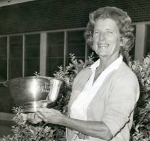 Photo of Jean Arendes Bibby holding tennis trophy bowl