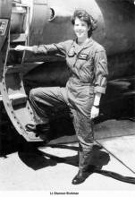 Photo of Shannon Workman in military aviation uniform; standing with one foot on plane step
