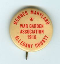 Yellow button with red letters from War Garden Association 1918