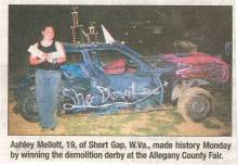 Newspaper clipping of woman standing by smashed derby car, Ashley Mellott