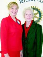 2 women standing in front of Rotary Club sign; Karen Johnson and Doris (Henaghan) Fisher 