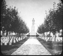 Antietam National Cemetery, stone path walk leading up to monument; grave markers on both sides with trees; 1880