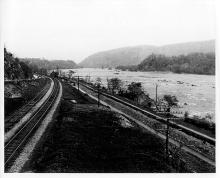 downstream at Sandy Hook, train tracks run parallel to canal