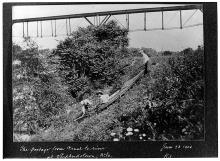 Shawnee Canoe club, the three members are traversing the slope from the towpath to the river below