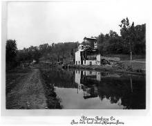 2 story Building along canal with canal boat outside; text reads "Potomac Refining Co. Four mile level above Harpers Ferry"