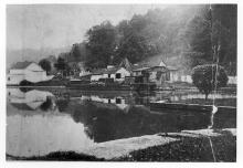 Lock 37; house and storage sheds off in the distance beside canal lock