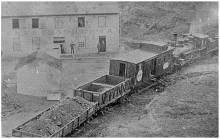 Cushwa warehouse, train passing by with load of coal; circa unknown