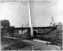 Toll bridge at Williamsport; boat in canal, boy stands near canal path; circa 1920s?