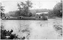 laden canal boat makes its way downstream, family on boat