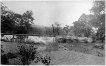 Five boats are moored in a boat basin near Two Locks