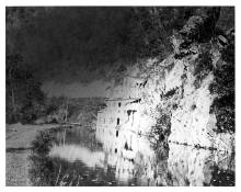 Cement Mill post operations, building abandon, wall of rock where bridge walkway once stood