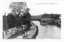 Cando Canal at Hancock; mules on walkway, boarded shanty and building in background