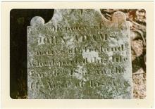 Photo of cemetery headstone with writing, "John Adams"