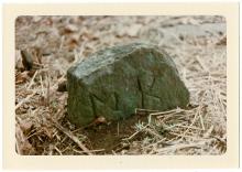 Large rock, this gravestone has "M.K." scraped into it