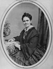 Formal photo of Isabella Fogg sitting by desk, circa 1862 