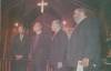 4 people standing in front of a church sanctuary for a picture