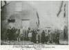 Photograph of multiple African Americans standing in front of a building