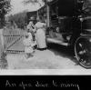 Book wagon on country road; women and children looking through books