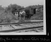 Book wagon parked near train track with family looking through books