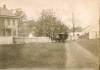 Book wagon with horse standing in front of a house