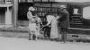 Book wagon on country road; women and children looking through books