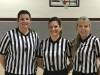 Photo of 3 women referees at basketball game, pose for picture
