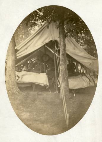 Circa 1862 photo of Antietam hospital; white tent pitched in wooded area