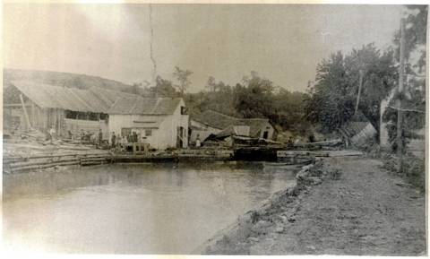 Lock 44 after 1889 Flood, homes destroyed in background and debris in canal