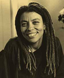 Kia Corthron with long dreadlocks poses for picture