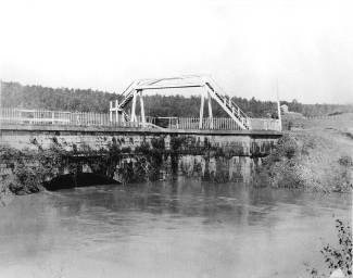 Sideling Hill Creek Aqueduct, a stone bridge with large arch; small walking bridge over the aqueduct