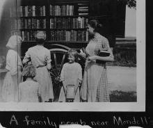 Book wagon with group of women and children looking through books