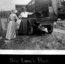Book wagon on side of the road with 2 women looking through books