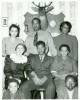 Family of 8 pose for portrait with a mounted dear head on the back wall