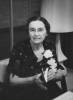 Photo of Mary Gertrude Walsh holding a book, wearing a flower corsage 